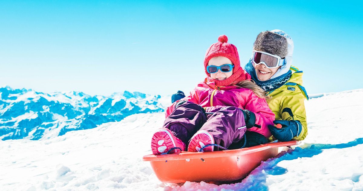 two kids sledding