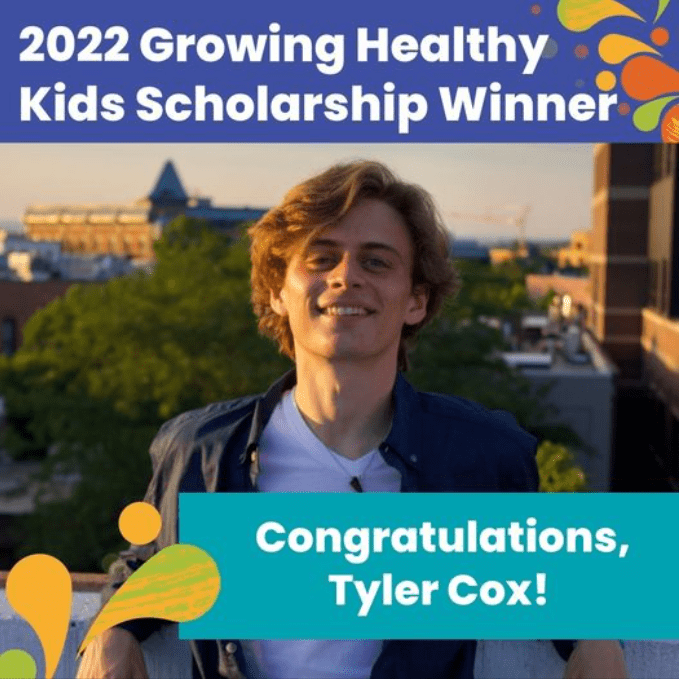 A person smiles outdoors with a cityscape in the background. Text on the image reads, "2022 Growing Healthy Kids Scholarship Winner. Congratulations, Tyler Cox!" The border features colorful abstract shapes.